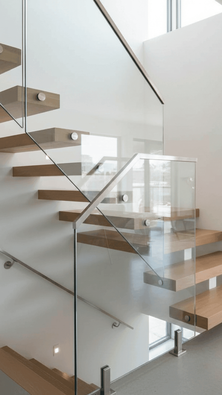 Custom glass railing on staircase in a modern home by Glass and Shower Doors